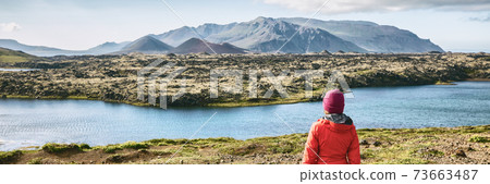Iceland hiking travel adventure - woman tourist walking in mountain landscape looking at amazing view of nature, panorama banner Iceland hiking travel adventure - woman tourist walking in mountain landscape looking at amazing view of nature, panorama banner 73663487