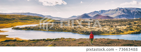 Hiking nature amazing landscape travel wanderlust woman hiker on holiday in Iceland. Panoramic banner hero view of icelandic lake Hiking nature amazing landscape travel wanderlust woman hiker on holiday in Iceland. Panoramic banner hero view of icelandic lake 73663488