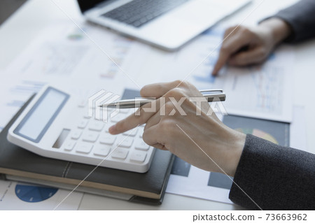 Financial businesswoman calculating corporate income tax data And analyzing charts of financial stocks that are in good condition with growth and progress, Investment in finance and accounting. 73663962