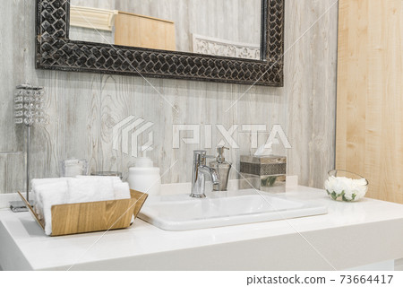 Close-up of a washbasin with a faucet in the bathroom Close-up of a washbasin with a faucet in the bathroom 73664417