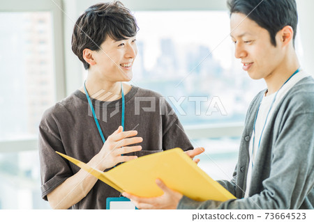 A businessman who consults on a project A businessman who consults on a project 73664523