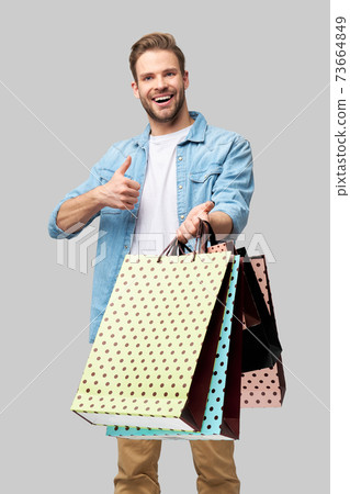 Portrait of a handsome young man with shopping bags Portrait of a handsome young man with shopping bags 73664849