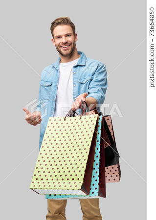 Portrait of a handsome young man with shopping bags Portrait of a handsome young man with shopping bags 73664850