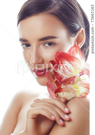young pretty brunette real woman with red flower amaryllis close up isolated on white background. Fancy fashion makeup, bright lipstick, creative Ombre manicured nails young pretty brunette real woman with red flower amaryllis close up isolated on white background. Fancy fashion makeup, bright lipstick, creative Ombre manicured nails 73665165