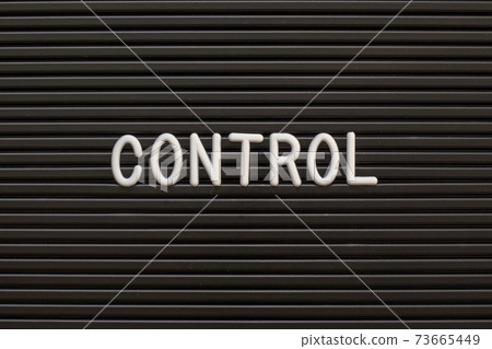 Black color felt letter board with white alphabet in word control background Black color felt letter board with white alphabet in word control background 73665449