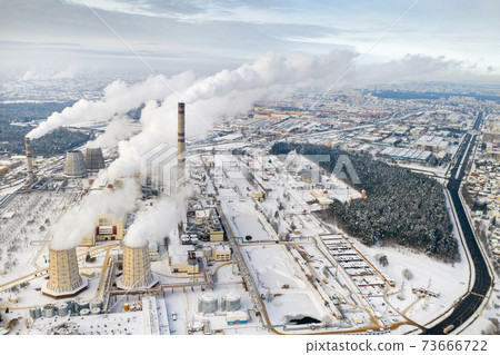 Thermal power plant in winter in the city of Minsk. Smoke is coming from the big Chimneys 73666722