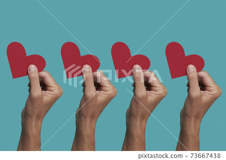 men with a red heart in their hands 73667438