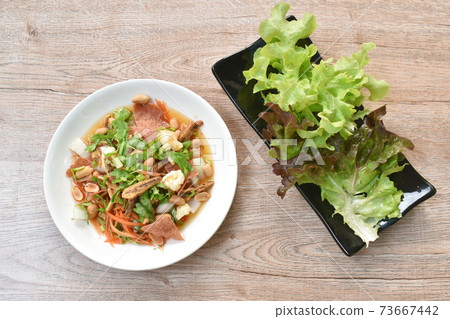 crispy fish with pork couple maw topping peanut in spicy and sour chili sauce salad on plate 73667442