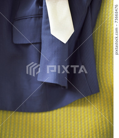 Suit And Tie On Yellow Surface 73668476