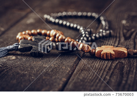 wooden cross on wood background. Close up. wooden cross on wood background. Close up. 73670003