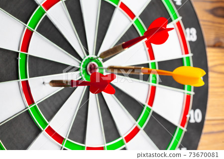 The darts on wooden background. Close up. The darts on wooden background. Close up. 73670081