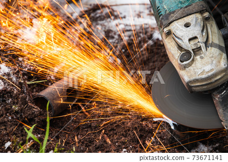Angle grinder works, sparks stream close up 73671141