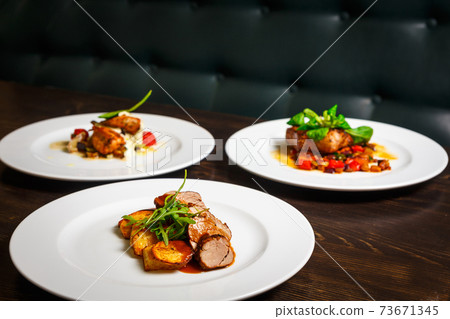 three different dishes of chicken, beef and pork 73671345