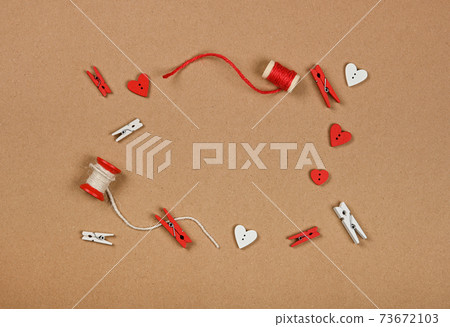 Frame of Valentine decorations on brown paper Frame of Valentine decorations on brown paper 73672103