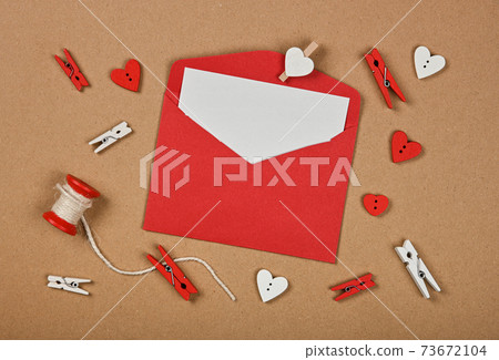 Red Valentine card envelope on brown paper 73672104