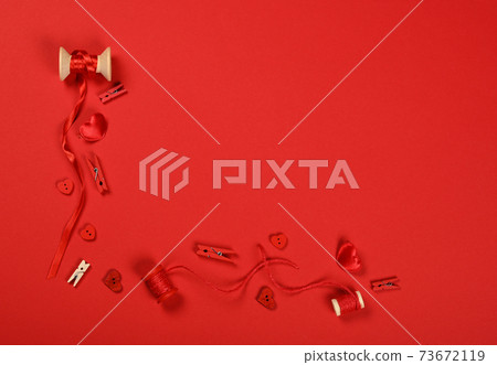 Packing Valentine gifts on red wrapping paper Packing Valentine gifts on red wrapping paper 73672119