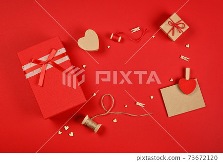 Valentine gifts and card on red wrapping paper Valentine gifts and card on red wrapping paper 73672120