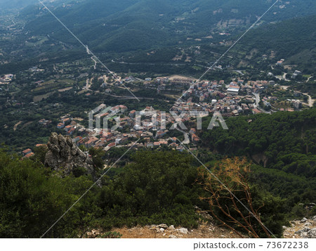 Aerial View of village Villagrande Strisaili with limestone rocks, mountains and green forest vegetation. Summer sunny day. Province of Nuoro, Sardinia, Italy, Europe 73672238
