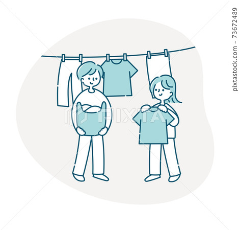 A couple hanging up the laundry 73672489