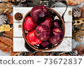 Rustic style of red apples in wooden basket on autumn background setup 73672837