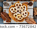 Top view of festive pretzels on the plate with autumn background setup 73672842