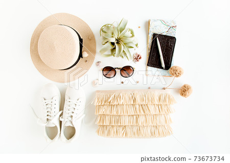 Woman fashion travel. Straw hat, bag with accessories, sneakers, succulent, sunglasses. Flat lay. Top view Woman fashion travel. Straw hat, bag with accessories, sneakers, succulent, sunglasses. Flat lay. Top view 73673734
