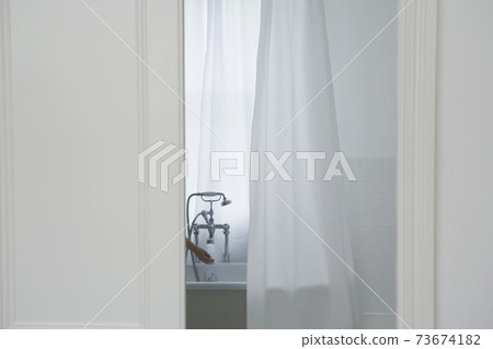 Woman's Hand Filling Bathtub Woman's Hand Filling Bathtub 73674182