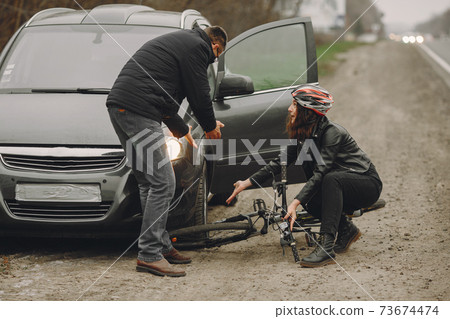 Road accident with cyclist man driver and car 73674474