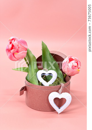 Valentine's Day flowers with hearts.Image with tulips on pink background for Valentine's Day, International Women's Day, birthday and declaration of love postcards, greeting cards and posters. 73675005