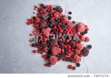 red berries scattered on a white background red berries scattered on a white background 73675174