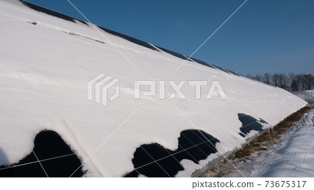 Snow on solar power plant panels Snow on solar power plant panels 73675317