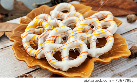 Glazed pretzels on the plate with autumn setup, season holiday concept 73677993