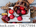Autumn setup of red apples on wooden background, seasonal pattern of healthy fruits 73677994