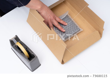 Hands of a woman doing wrapping work 73680115