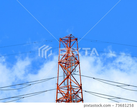 High-voltage power line tower towering in the blue sky High-voltage power line tower towering in the blue sky 73681258