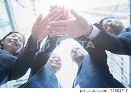 business team holding hands 73683747