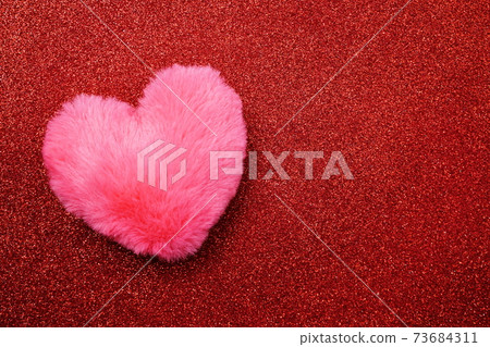 Valentine's Day Background with pink heart on red glitter background Valentine's Day Background with pink heart on red glitter background 73684311