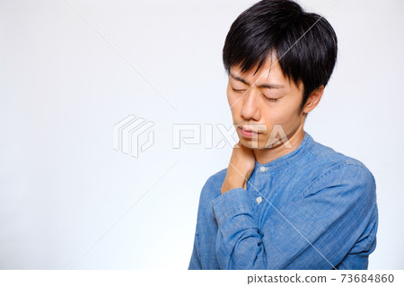 Japanese man suffering from stiff shoulders Japanese man suffering from stiff shoulders 73684860