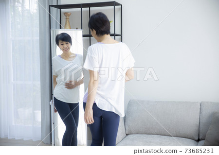 A woman in her 50s who checks her proportions by looking at her A woman in her 50s who checks her proportions by looking at her 73685231