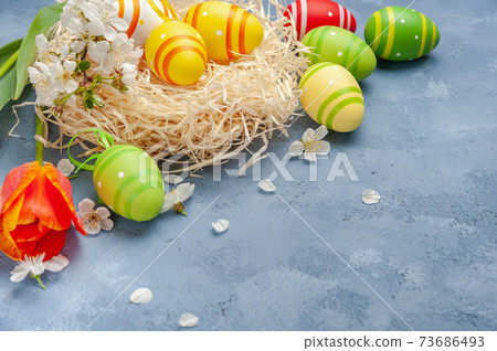 Happy easter card with painted eggs and flowers 73686493