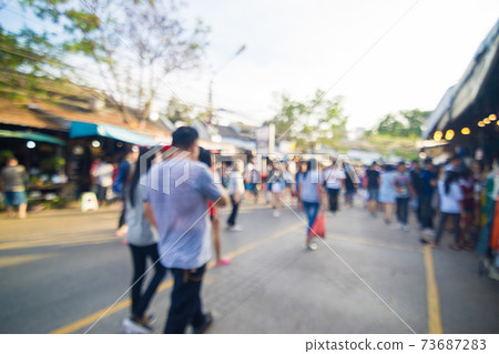 Blurred crowd of anonymous people walking on outdoor street Blurred crowd of anonymous people walking on outdoor street 73687283