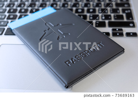 Passport on a laptop On Computer Keyboard . - Stock Photo 