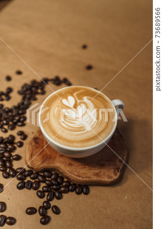 Hot Drink,Coffee latte in a cup Brown background 73689566