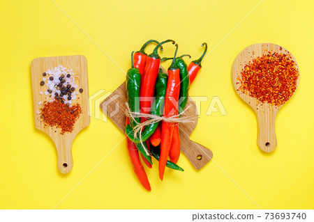 Red Chili Peppers. Green, Peppers. Flat lay, top view. kitchen herbs. Copy space for your text Red Chili Peppers. Green, Peppers. Flat lay, top view. kitchen herbs. Copy space for your text 73693740