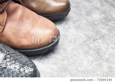 Group of brown and black women shoes. Advertising concept Group of brown and black women shoes. Advertising concept 73694195