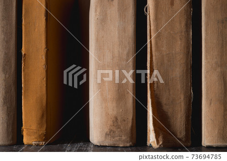 Vintage books for reading, literature, poetry and library thematic background. Vintage books for reading, literature, poetry and library thematic background. 73694785
