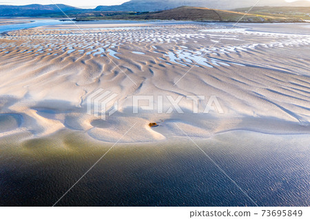 The coast between Kiltoorish bay beach and the Sheskinmore bay between Ardara and Portnoo in Donegal - Ireland 73695849