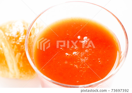 Tomato juice in a glass. 73697392