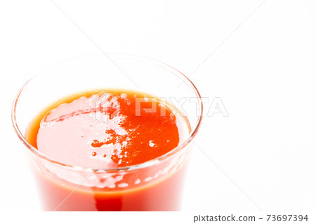 Tomato juice in a glass. Tomato juice in a glass. 73697394