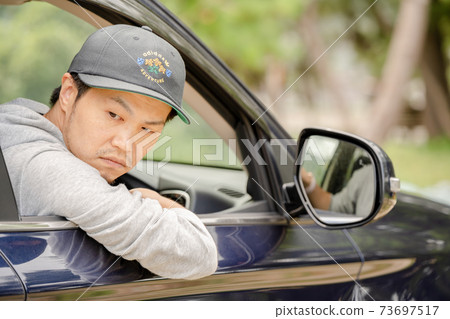 A man driving a car A man driving a car 73697517
